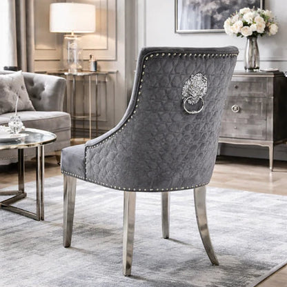 2 Grey velvet dining chairs with chrome legs & lion knocker